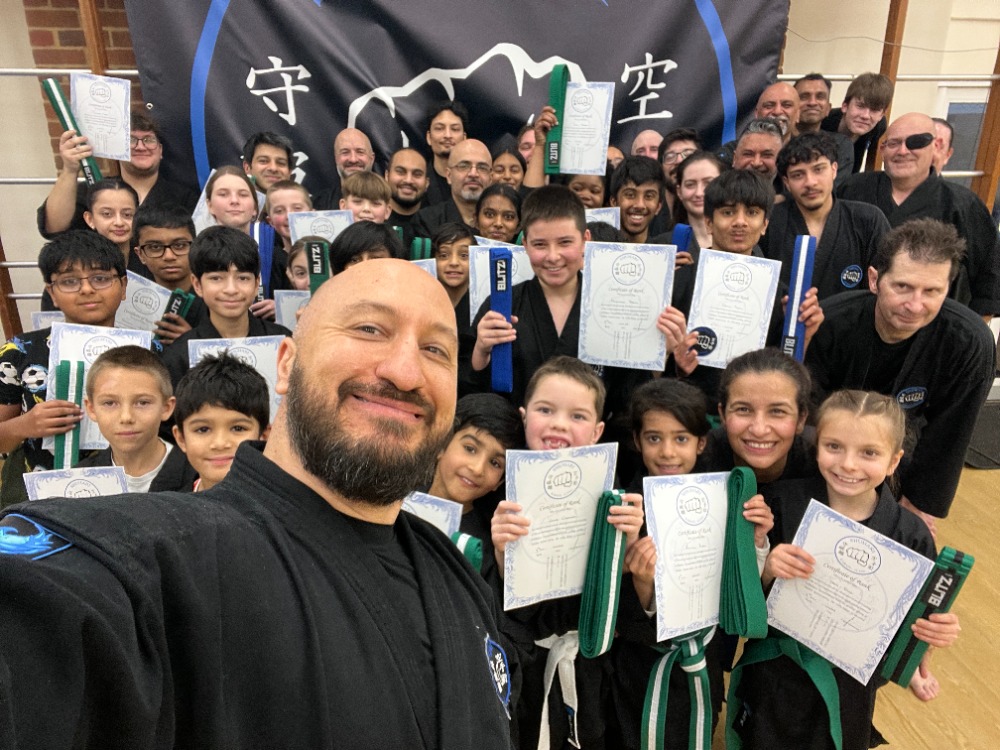 Children practicing martial arts techniques in a Shuhari Self Defence class in Slough