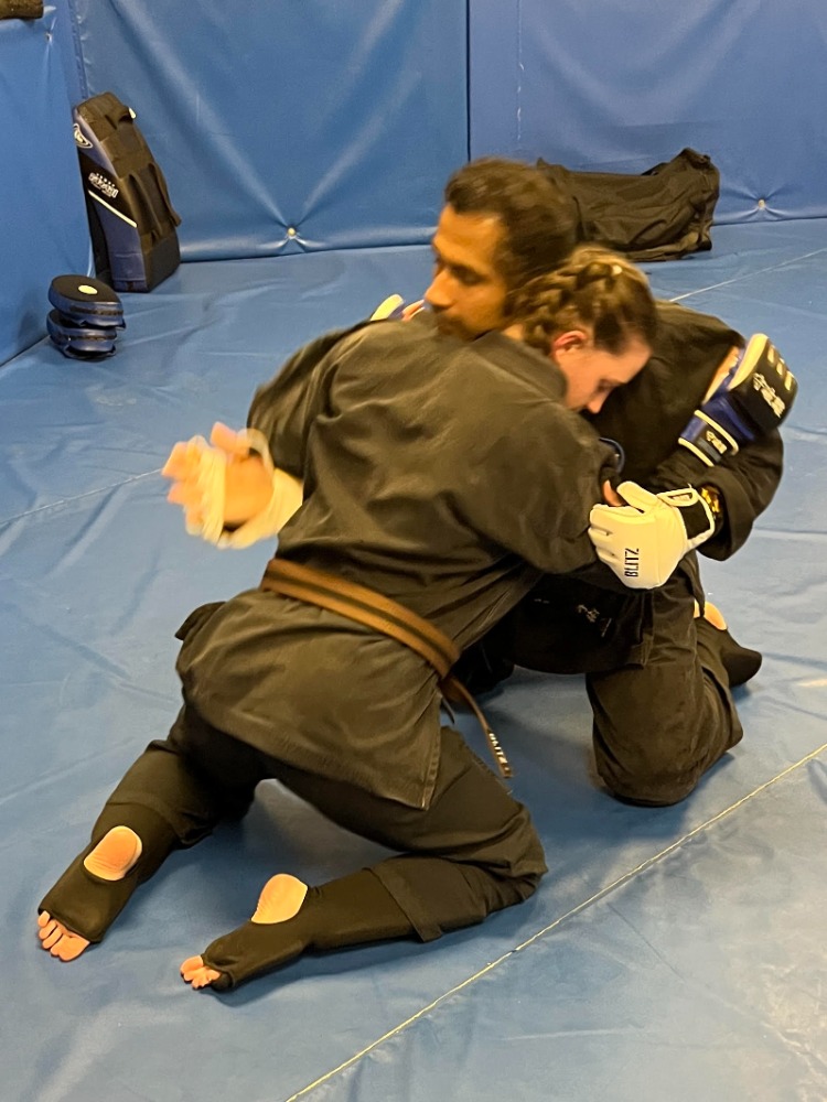 Karate vs BJJ comparison: students drilling striking and grappling techniques at Shuhari in Slough