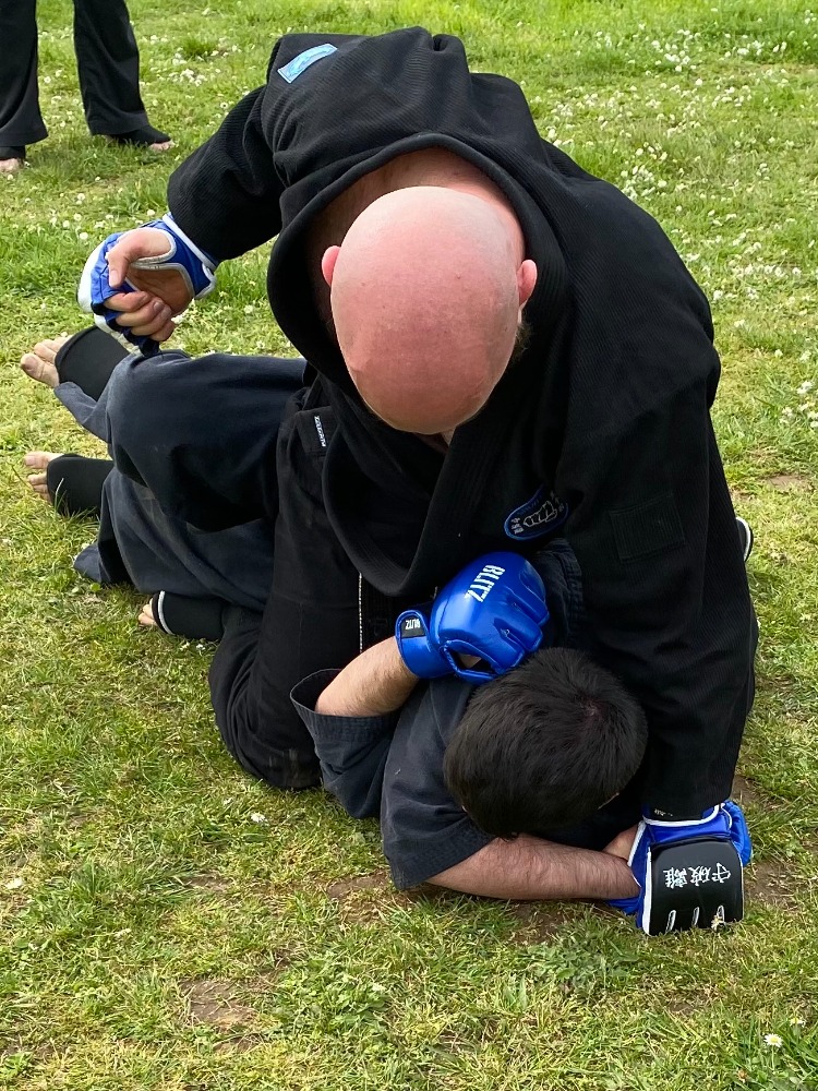 Students training standing and ground martial arts techniques at Shuhari Self Defence in Berkshire