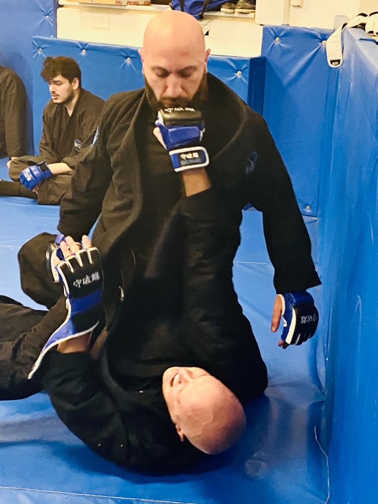 Karate vs BJJ comparison: students drilling striking and grappling techniques at Shuhari in Slough