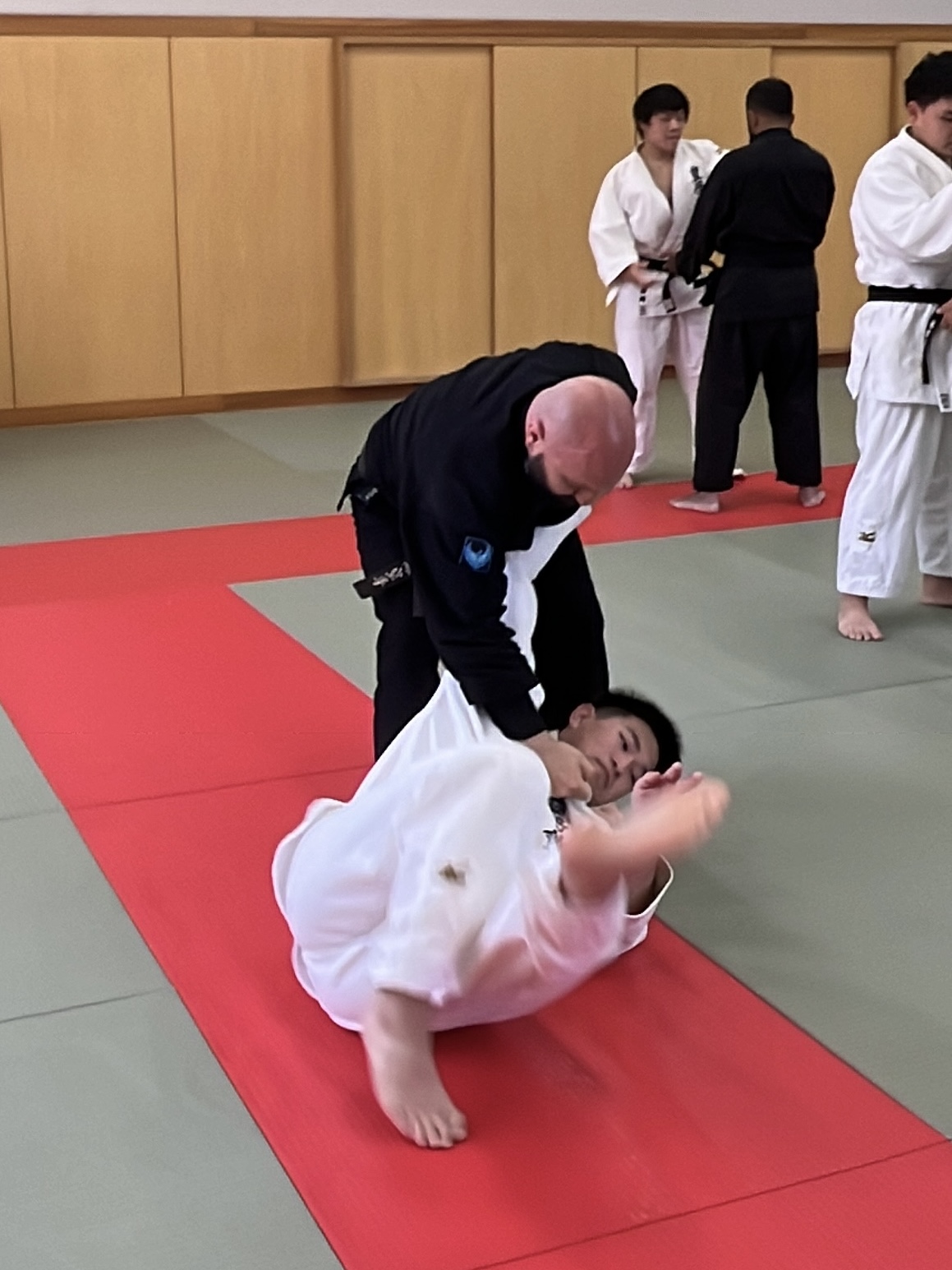 Shuhari instructor from Bracknell completing a judo throw on the mat during training in Japan