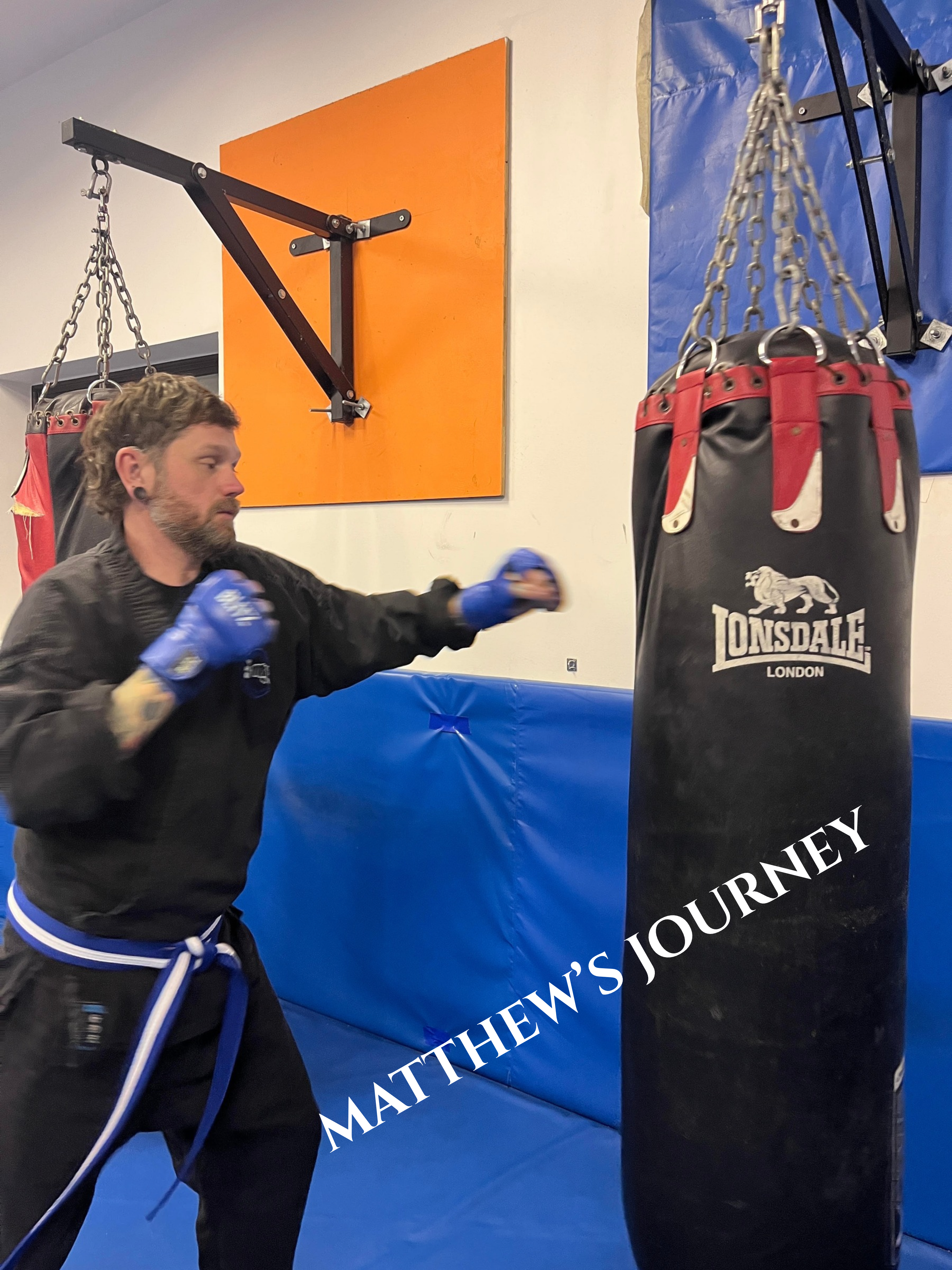 Matthew practising punches on a heavy bag at Shuhari Self Defence & Martial Arts