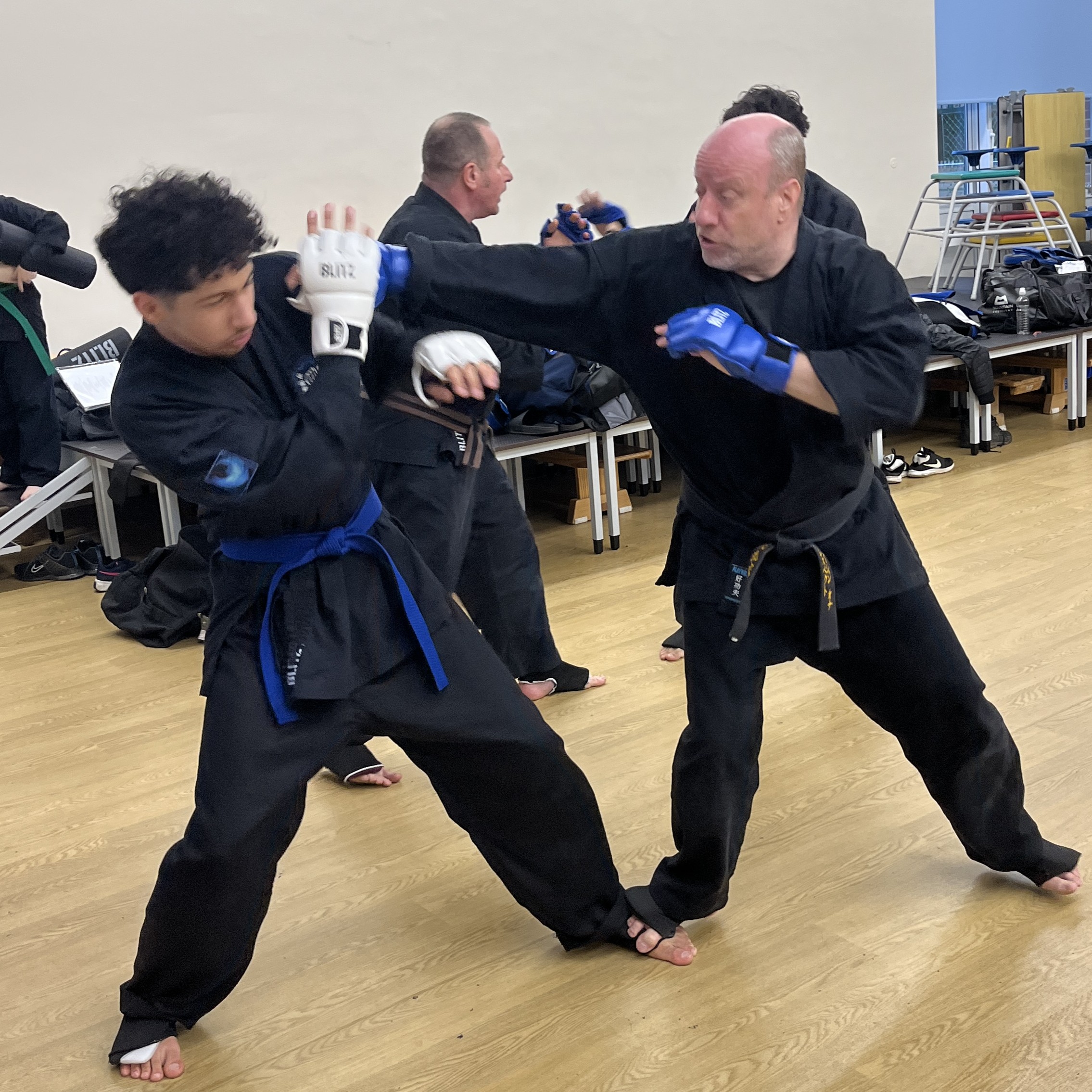 Brian Southon of Shuhari Self Defence Cippenham sparring with a skilled teenager student in a karate class