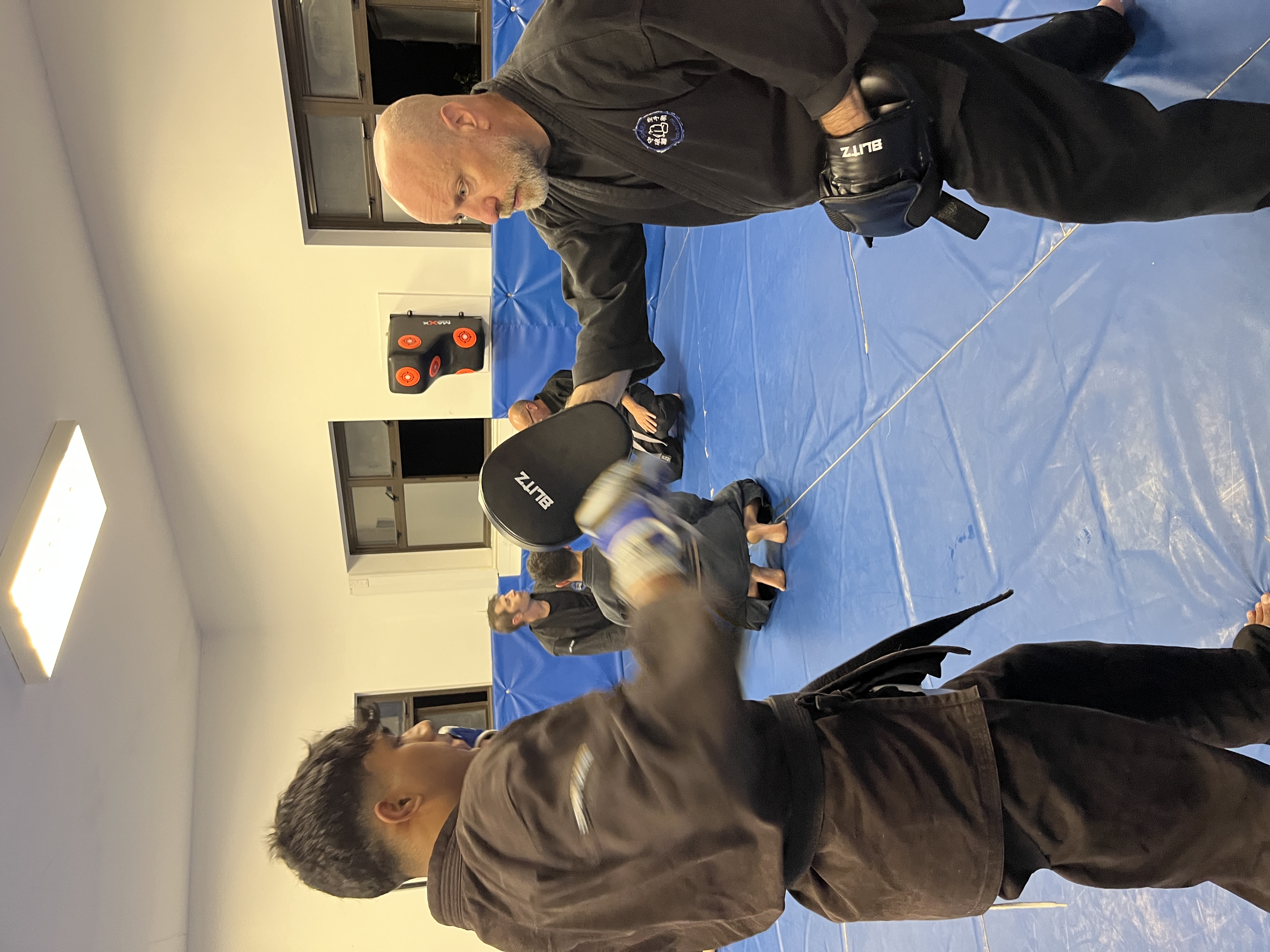 Brian Southon of Shuhari Self Defence Cippenham teaching pad work in an MMA class for adults