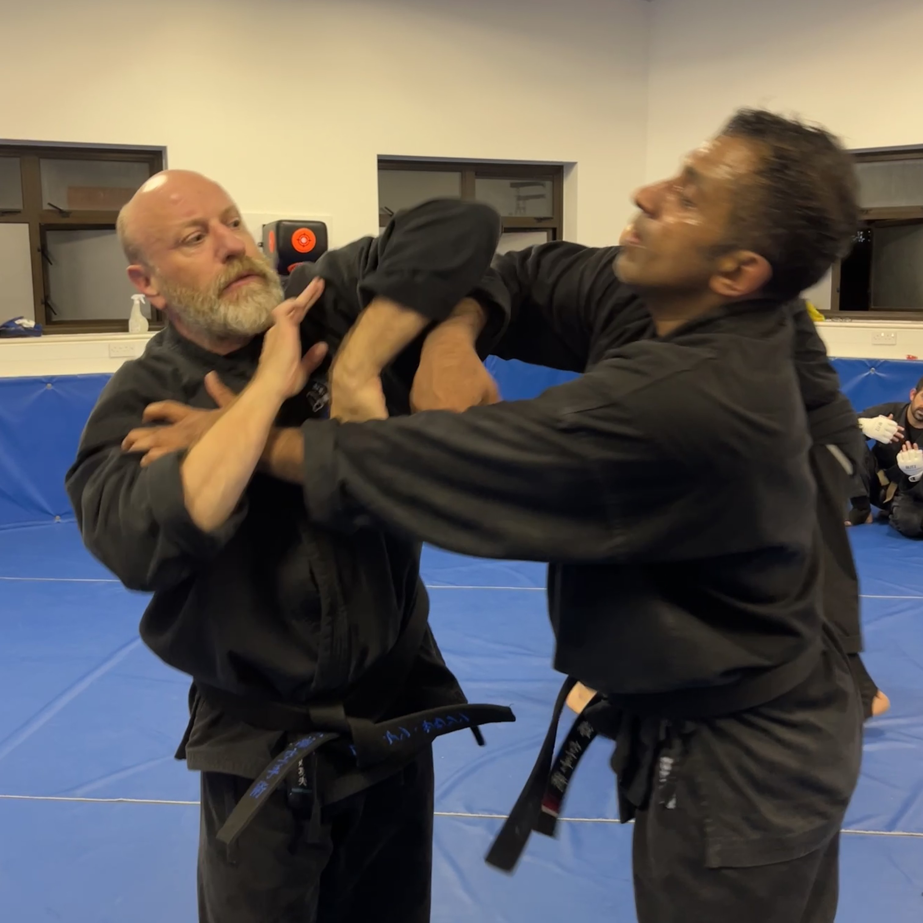 Brian Southon of Shuhari Self Defence Cippenhampracticing chi sao sticky hands drills in an adults martial arts class