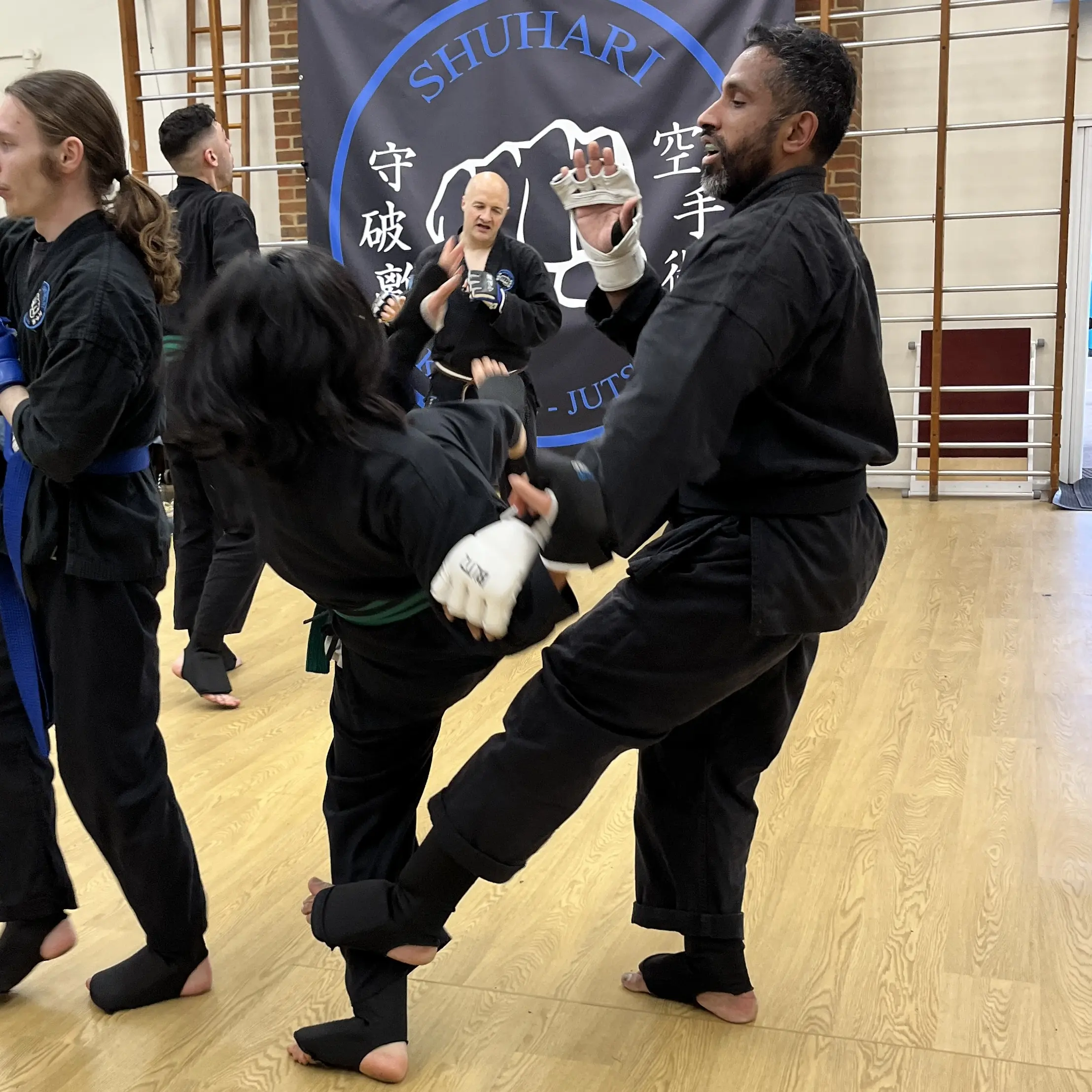 John Moses of Shuhari Self Defence Bracknell  sparring with a student in a karate grading