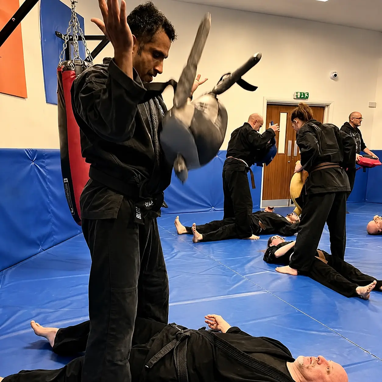 John Moses of Shuhari Self Defence Bracknell practicing conditioning with a Bulgarian Bag in a martial arts class