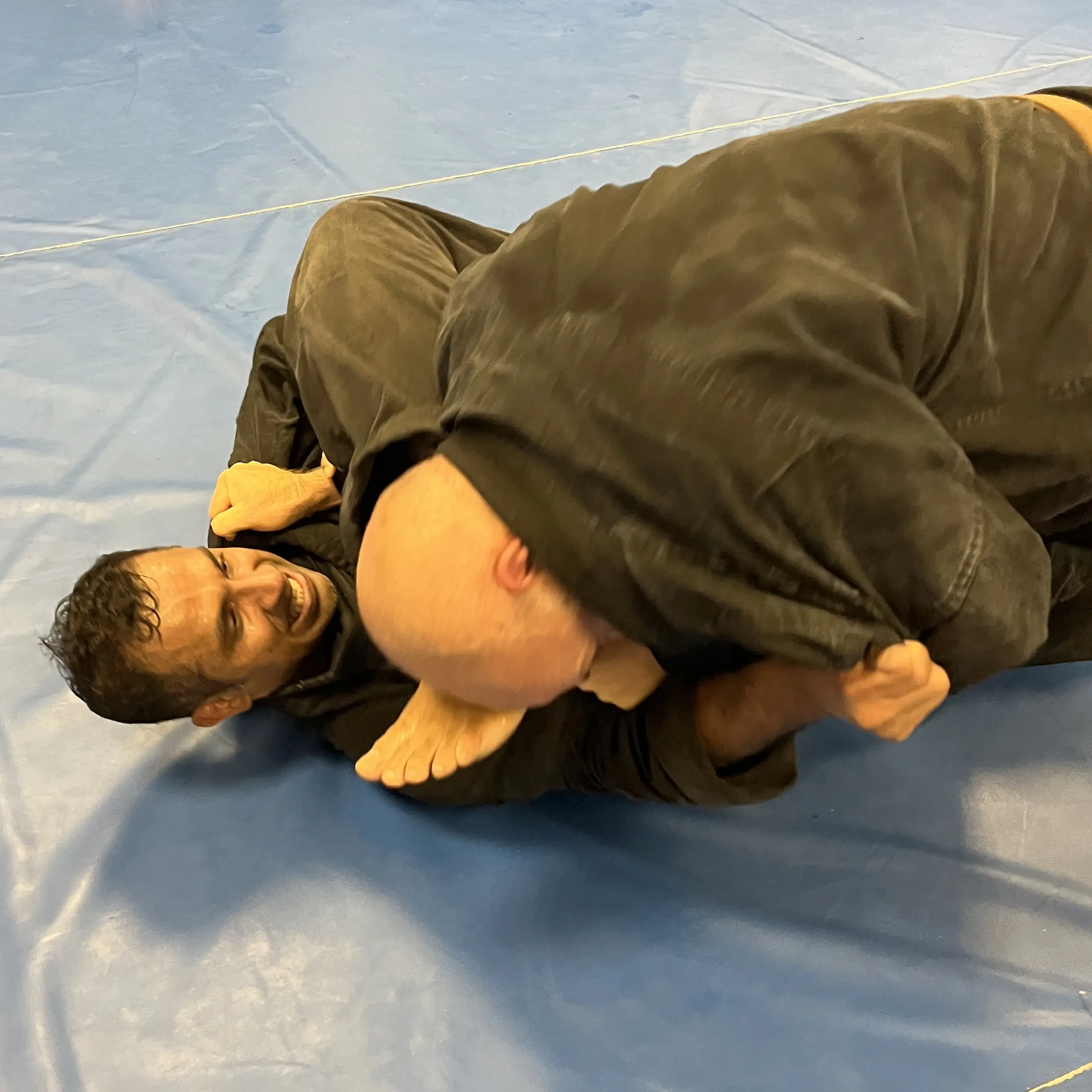 John Moses of Shuhari Self Defence Bracknell practicing groundwork in an MMA class