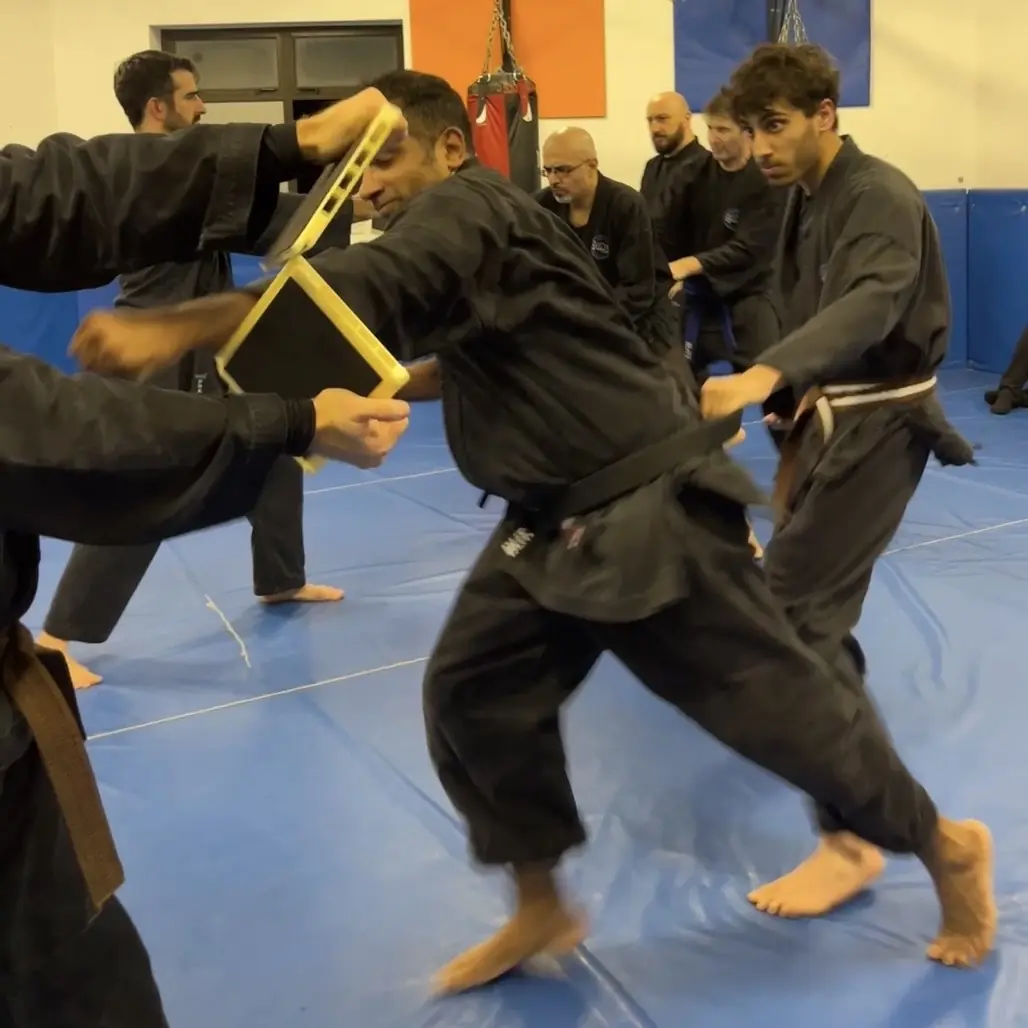 John Moses of Shuhari Self Defence Bracknell practicing tameshiwari breaking techniques in a karate class