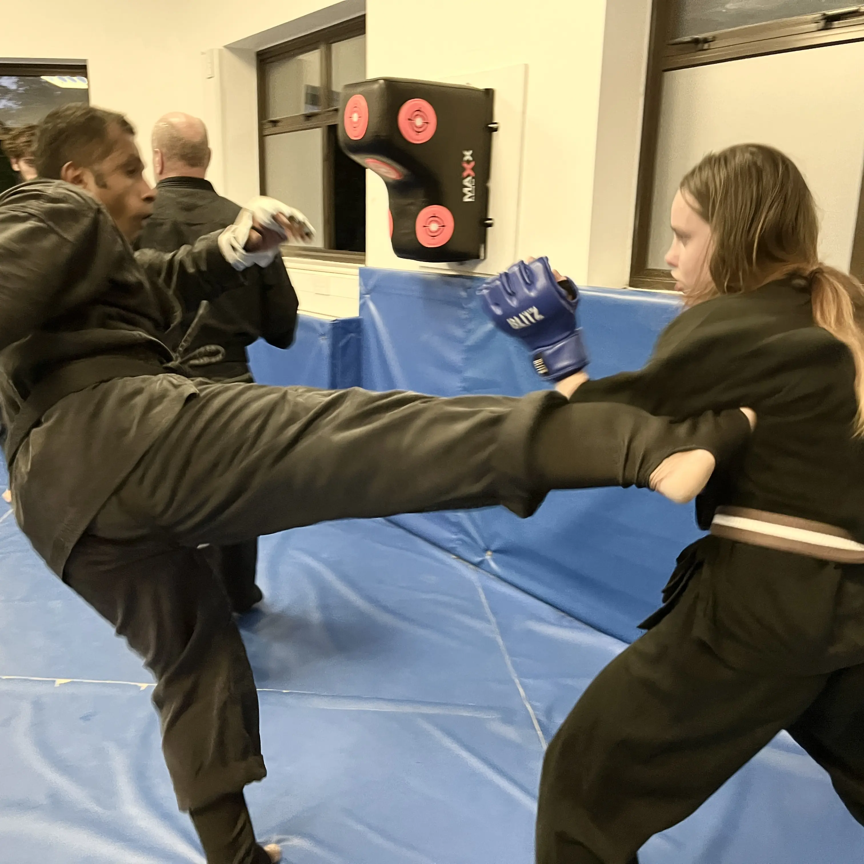 John Moses of Shuhari Self Defence Bracknell sparring in a martial arts session assessing a karate student