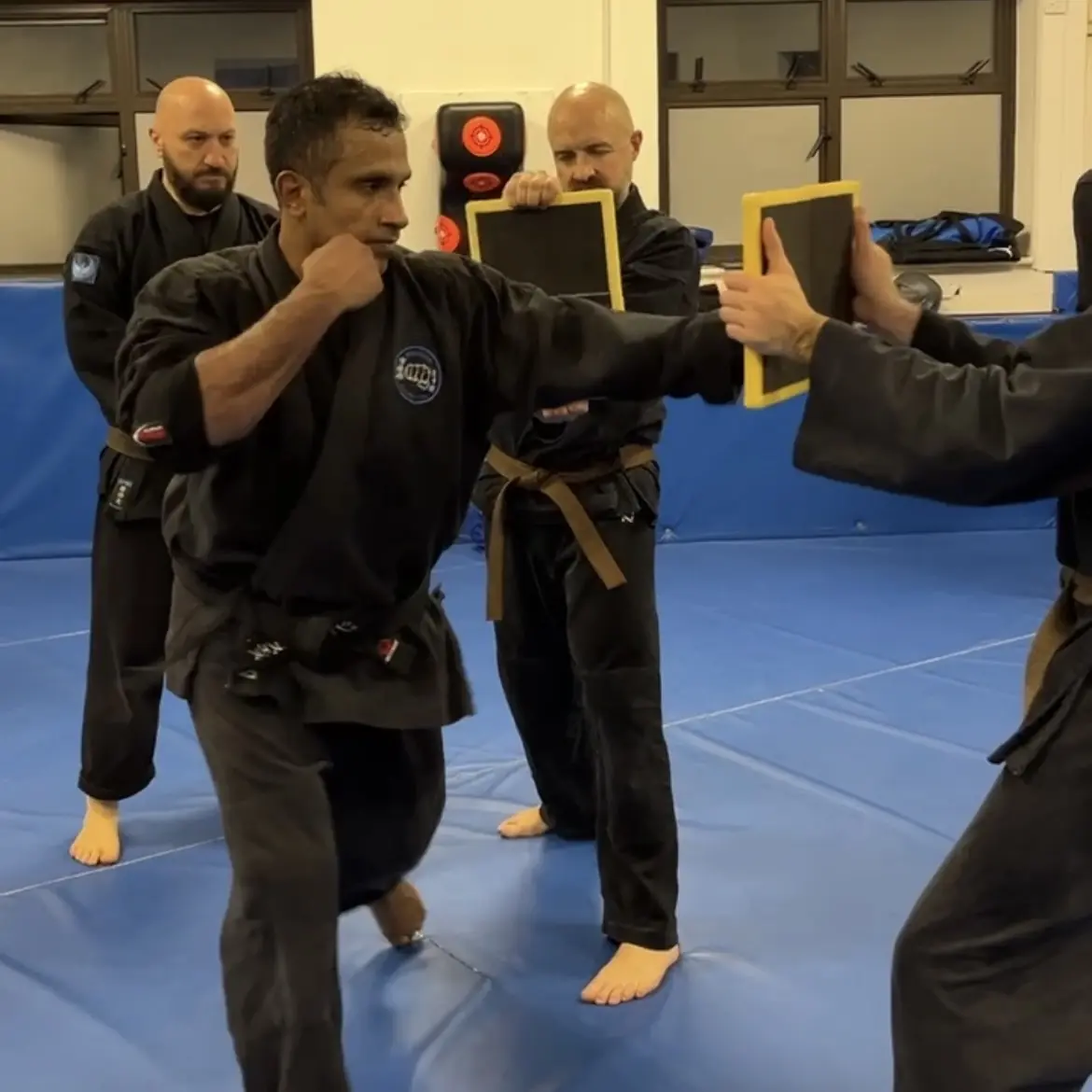 John Moses of Shuhari Self Defence Bracknell learning tameshiwari breaking techniques from Olgun Tiltay in a karate class