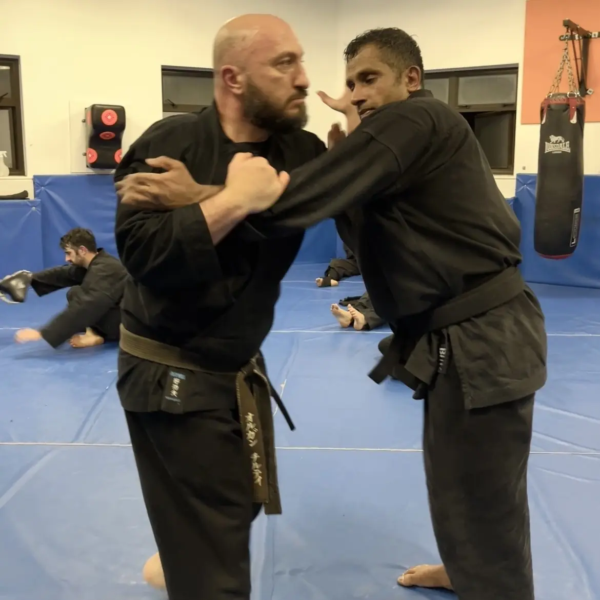 John Moses of Shuhari Self Defence Bracknell learning vertical grappling concepts from Olgun Tiltay in a martial arts class