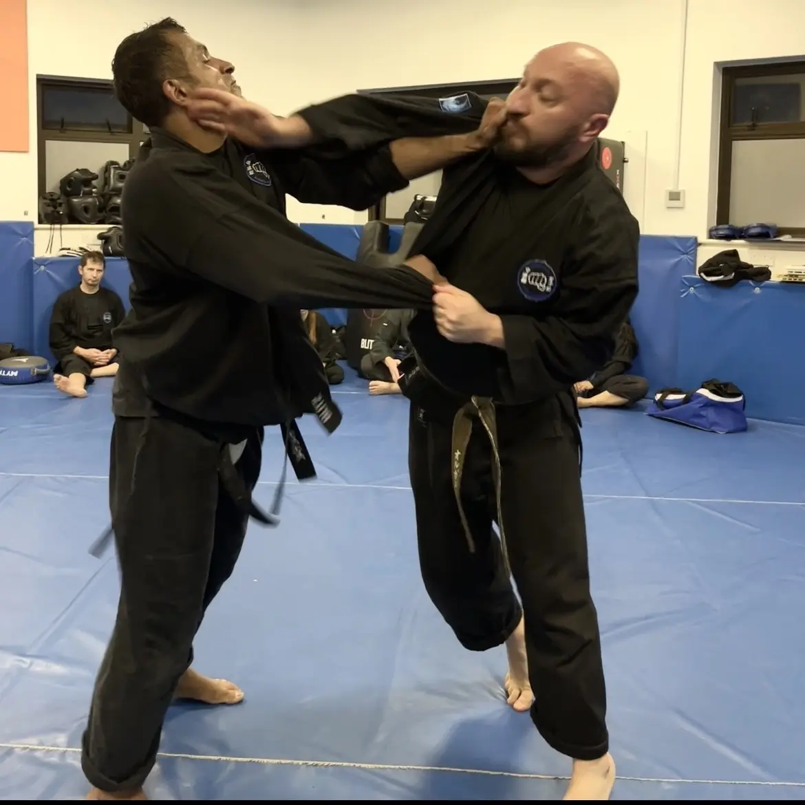 John Moses of Shuhari Self Defence Bracknell learning vertical grappling from Olgun Tiltay in a martial arts class
