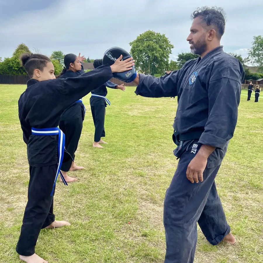 John Moses of Shuhari Self Defence Bracknell teaching karate to a beginner teenager student