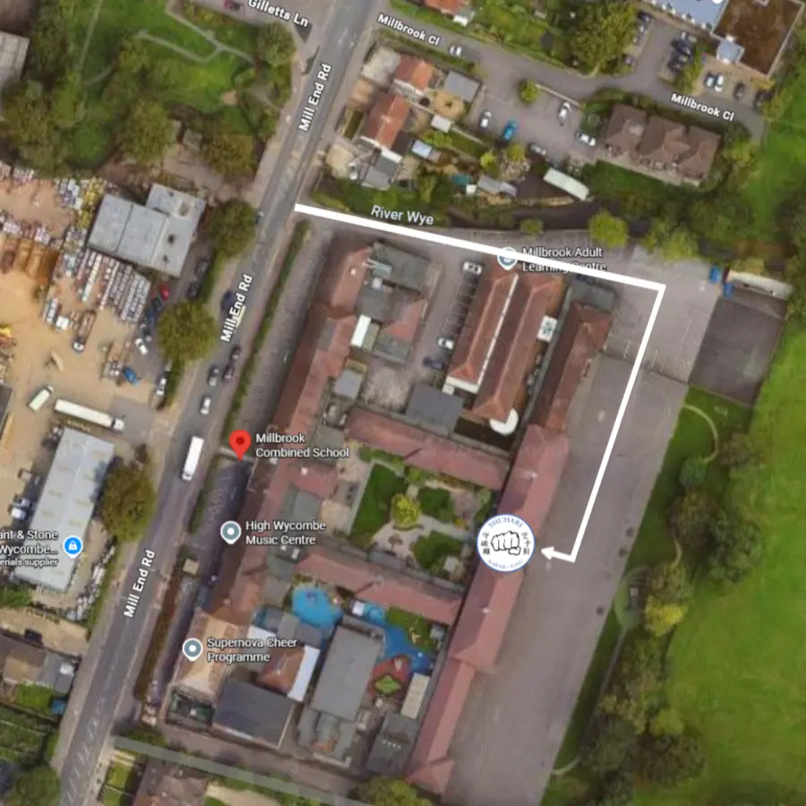 Aerial view of Millbrook Combined and Nursery School showing the route from Mill End Road, down the access road on the left of the building, to the hall entrance half way along the rear car park