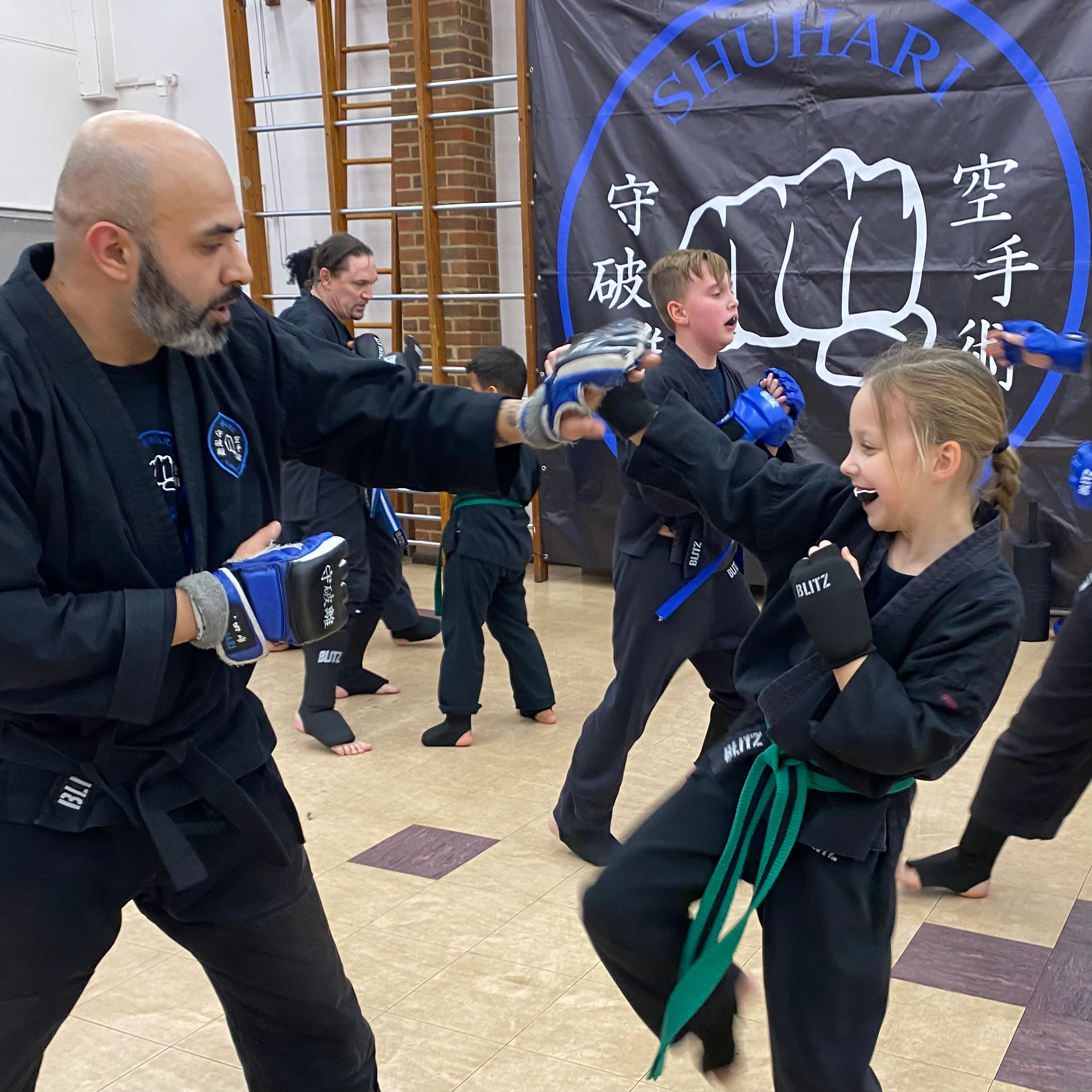 Majid Khalid of Shuhari Self Defence Slough sparring with a student in a martial arts grading in Maidenhead