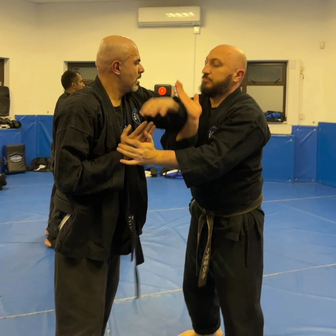 Majid Khalid of Shuhari Self Defence Slough learning vertical grappling from his instructor Olgun Tiltay in a martial arts class Majid Khalid of Shuhari Self Defence Slough learning vertical grappling from his instructor Olgun Tiltay in a martial arts class