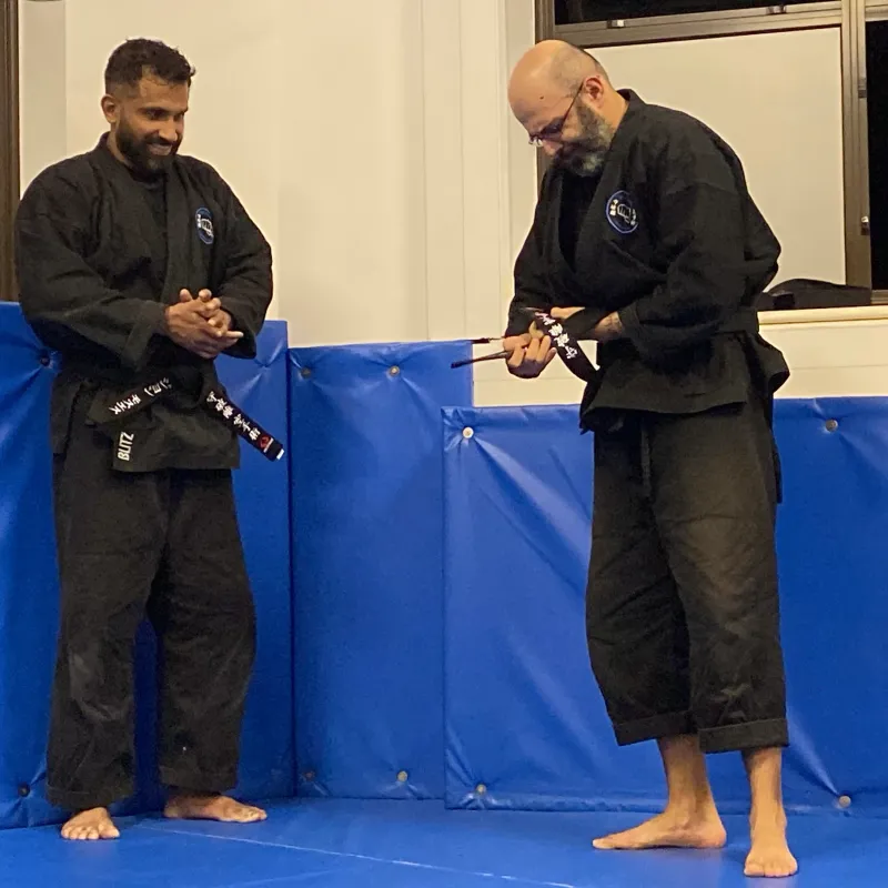 Majid Khalid of Shuhari Self Defence Slough after his grading in the dojo with fellow instructor John Moses