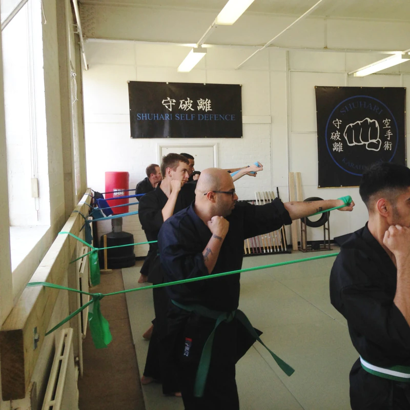 Majid Khalid of Shuhari Self Defence Slough practicing karate basics with resistance bands